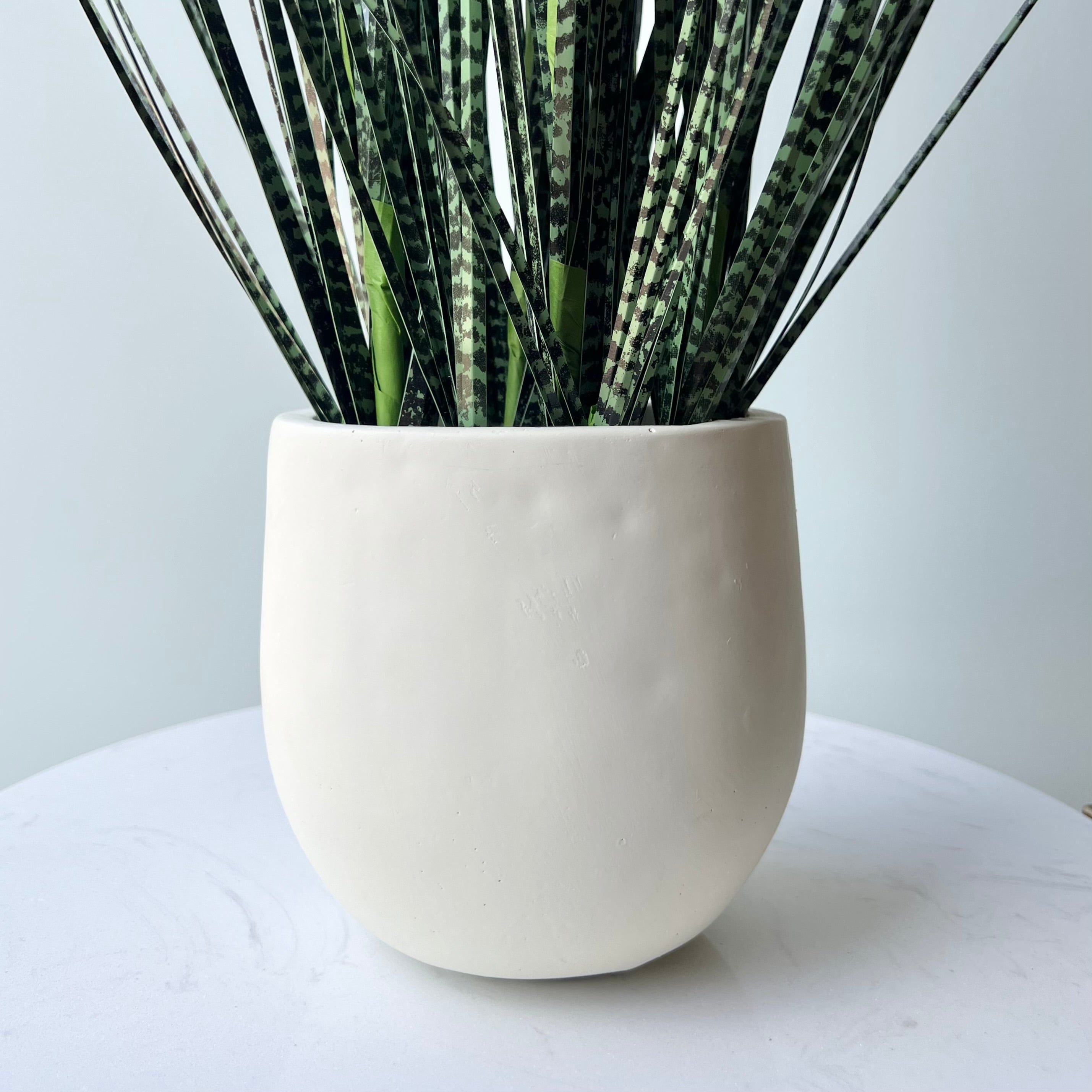 Realistic Artificial Mottled Onion Grass in Stone-look Planter AHCH-1523 by The Faux Flower Company